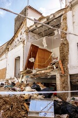 House damaged by the flood caused by the intense rains of the Dana over the Valencian Community with furniture and debris and cordoned off by police tape