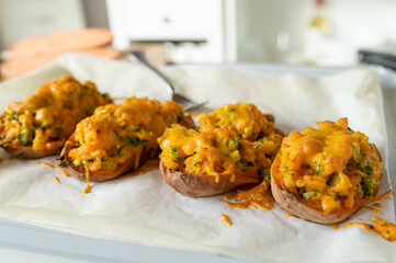 Delicious homemade filled and baked jacked potatoes with broccoli and cheddar cheese on kitchen...