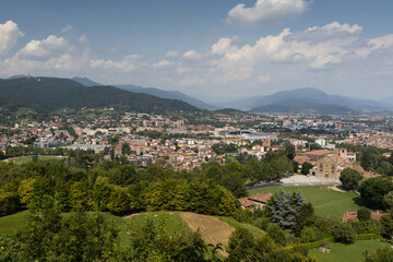 Obraz premium Aerial summer view of the new city of Bergamo (Citta Bassa) from the city walls of the old town (Citta Alta), in Lombardy, Italy. Copy space above.