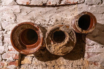 Protruding pipes in a wall in an old bunker in Normandy, France