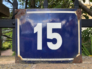 Rusty metal sign that says number 15