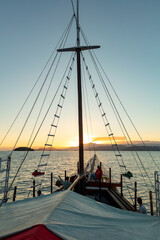 Obraz premium View from a tourist catamaran boat on Ilha Grande (Big Island), sunset in Angra dos Reis Bay, beach vacation on the coast of Rio de Janeiro, Brazil