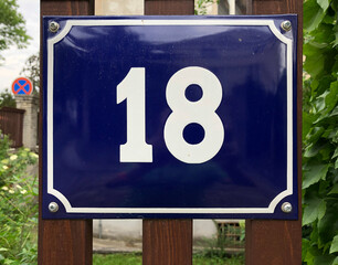 Blue metal sign that says number 18