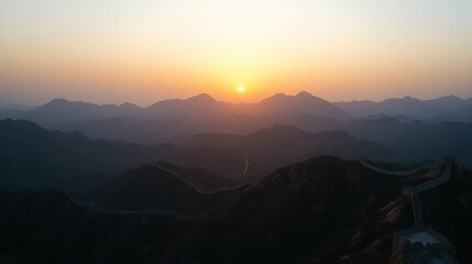 Fototapeta premium Breathtaking Sunset Over Mountain Landscape with Great Wall Silhouette and Rolling Hills, Capturing the Essence of Nature's Beauty at Dusk