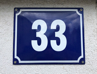 Blue metal sign that says number 33