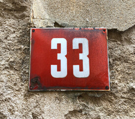 red metal sign that says number 33