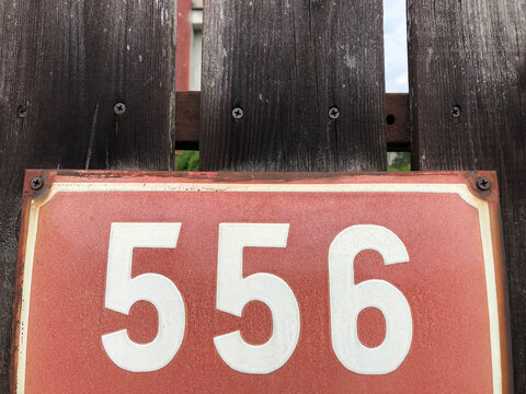 Red metal sign that says 556
