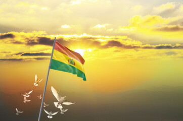 Bolivia flag waving with flying doves against sunset or sunrise. Bolivia flag for Republic Day and...