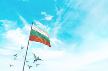 Bulgaria flag waving with flying doves in beautiful sky. Bulgaria flag for Republic Day and Independence Day.
