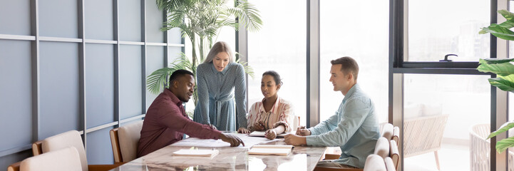 Diverse young business team working on project strategy together, meting for marketing analysis,...