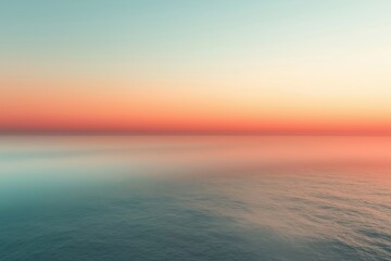 Fototapeta premium Tranquil ocean view at sunset with soft pastel colors reflecting on calm water