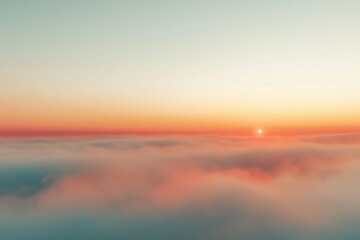 Fototapeta premium Golden sunrise rising above soft clouds at dawn over tranquil landscape in early morning light