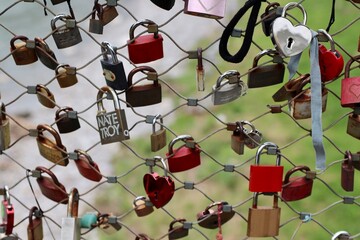 Salzburg, Austria - October 1 2024: Love Locks Attached to Bridge Fence Symbolizing Commitment and Romance