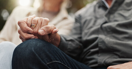 Elderly couple, love and holding hands for bonding, support and marriage together outdoors....