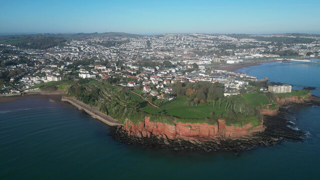 Torbay, Devon, England: DRONE VIEWS: The drone circles Roundham Head showing Paignton, Paignton Pier, Torbay, Torquay and Thatcher Rock. Torbay is a popular UK holiday destination (Clip 5).