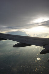 Obraz premium Airplane wing and clouds, taken on an airplane photo