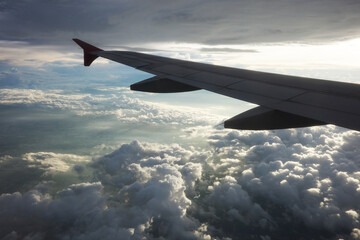 Obraz premium Airplane wing and clouds, taken on an airplane photo