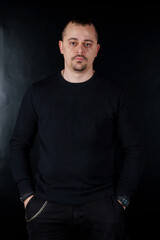Obraz premium Confident Male Portrait Against a Dark Background