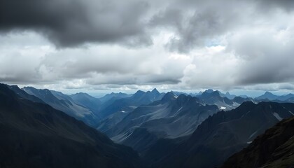 Obraz premium Storm clouds swirling above a rocky mountain range with copy space