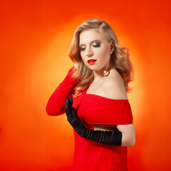 Fototapeta premium Glamorous Woman in Red Dress with Beauty Makeup