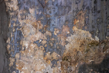 Old wall fragment with scratches and cracks