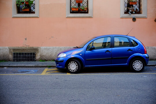 Vibrant blue citroen c3 pluriel parked on a city street, highlighting urban parking and european car culture