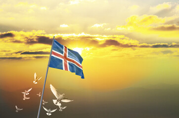 Iceland flag waving with flying doves against sunset or sunrise. Iceland flag for Republic Day and...