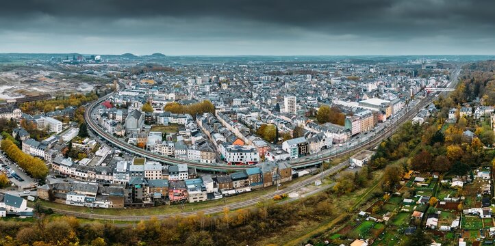 Aerial drone panoramic view of Esch-sur-Alzette, Luxembourg showcasing urban landscape and surrounding nature in fall