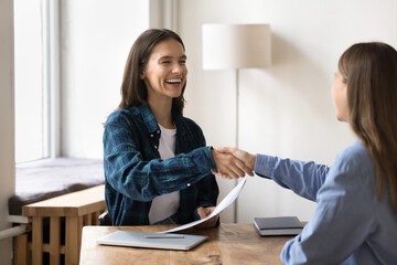 Women shaking hands, express mutual respect, congratulate each other with successful negotiation or...