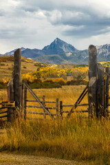 Rustic fence frames Mt Sneffles in the Fall season