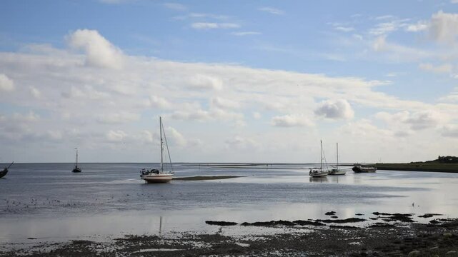 Timpelapse of sailboats showing the uprising tidal movement in the Wadden Sea, Holland