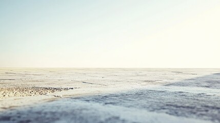 Obraz premium A serene, expansive landscape with a clear sky and distant horizon.