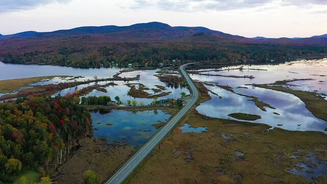 Tupper Lake in Adirondack, NY State, Moody Section, Spectacular Sunset in Fall aerial drone pan right