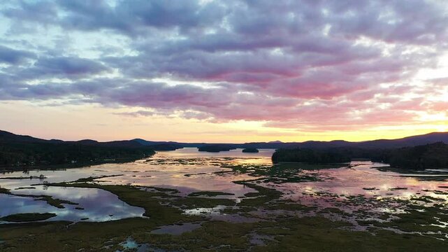 Tupper Lake in Adirondack, NY State, Moody Section, Spectacular Sunset in Fall aerial drone up and pan right