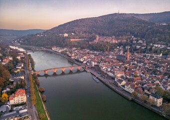 Fototapeta premium Aerial view of River Neckar and old town of Heidelberg at sunset, Germany. Heidelberg is a popular tourist destination due to its romantic cityscape.