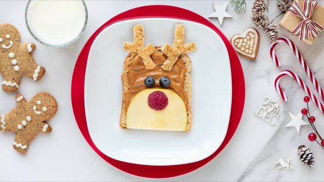 Christmas reindeer sandwith for kids in stop motion animation. Fun food festive breakfast for kids with peanut better and fruit