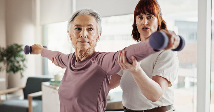 Weights, physiotherapist and senior woman consulting for wellness, mobility and physical therapy. Healthcare, professional and person with dumbbells for patient for rehabilitation medical service