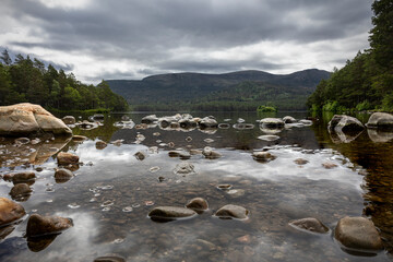 The stones protruding above the water in the lake of Loch an Eilein, in the northwest of Scotland...