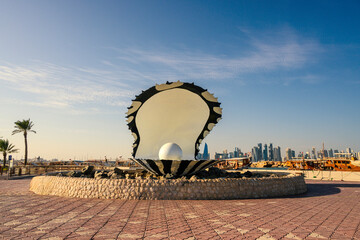 Pearl statue fountain and tall buildings behind it in Souq Waqif district of Doha, Qatar