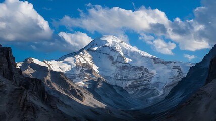 Fototapeta premium Majestic Snow-Capped Mountain Peak with Dramatic Shadows and Vibrant Blue Sky in Hyperrealistic Detail