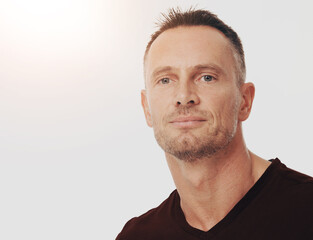 Fototapeta premium Portrait, mature man and confidence with hair transplant, treatment and pride on white background. Face, person and model with mockup space, calm and grooming routine with stubble, shine and texture