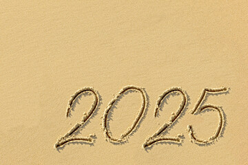 Inscription 2025 on the sand