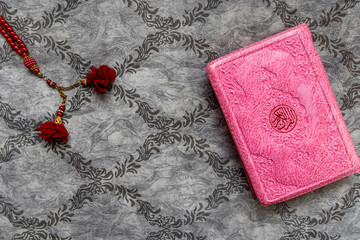 "uskudar, istanbul 16.11.2024: There is a wonderful Quran Kareem standing on a white background. There is a very elegant rosary next to it. isolated on white background. clean close-up.