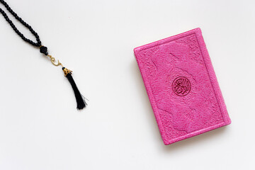 "uskudar, istanbul 16.11.2024: There is a wonderful Quran Kareem standing on a white background. There is a very elegant rosary next to it. isolated on white background. clean close-up.