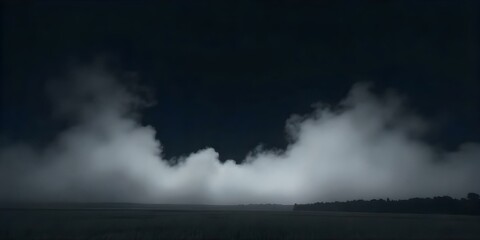 A dark, moody landscape with a low horizon and thick fog or mist obscuring the details. The sky is dark and ominous, creating an atmospheric and mysterious scene.