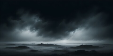 Obraz premium A dark, moody landscape with a low horizon and thick fog or mist obscuring the details. The sky is dark and ominous, creating an atmospheric and mysterious scene.