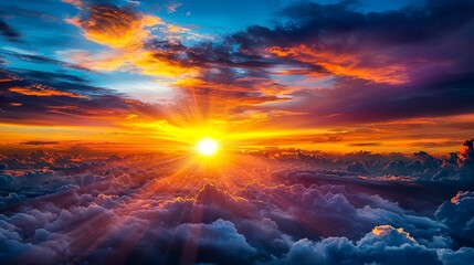 Obraz premium A sunset over the clouds with the sun shining through the clouds