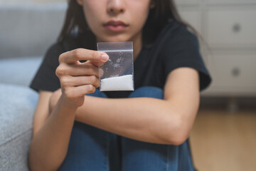 Anti drugs, drug addict asian young woman, girl hand holding heroin or cocaine in plastic bag, use...