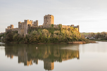 Pembroke Castle in Pembrokeshire, Wales, with reflections.