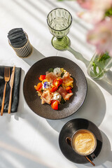 Hearty breakfast in a restaurant with prosciutto, tomatoes and cream cheese